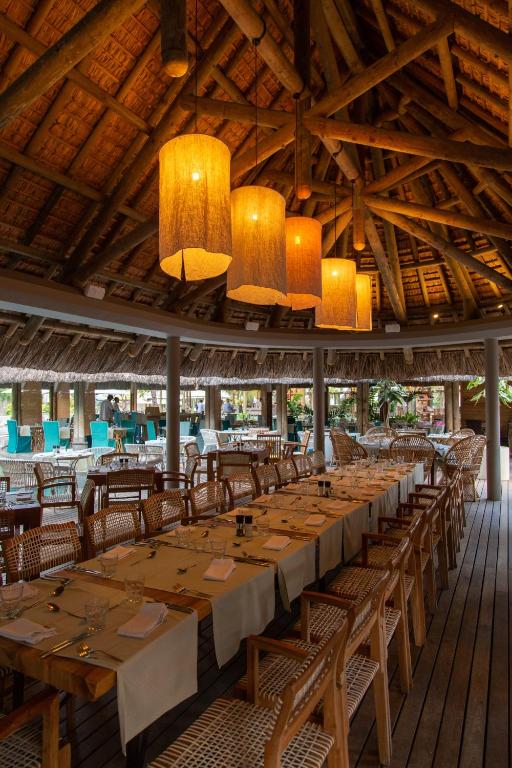 Restorāna iekārtojums ar koka mēbelēm un elegantām lampām, kas rada silto un viesmīlīgo atmosfēru. Pateicoties atvērtajai telpai un dabīgajiem elementiem, tas ir lielisks vieta relaksācijai un draudzīgām sanākšanām.