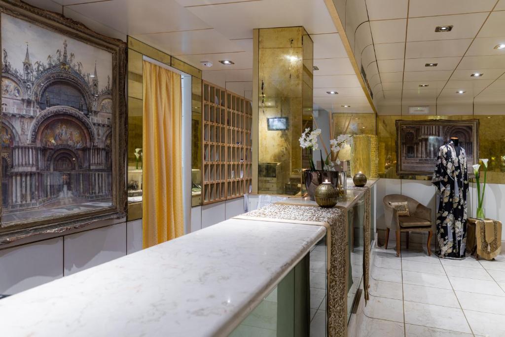 Elegants interjers ar gleznām un greznu dekoru. Attēlā redzams stilīgs apģērbs un izsmalcināti aksesuāri, kas rada viesmīlīgu atmosfēru.