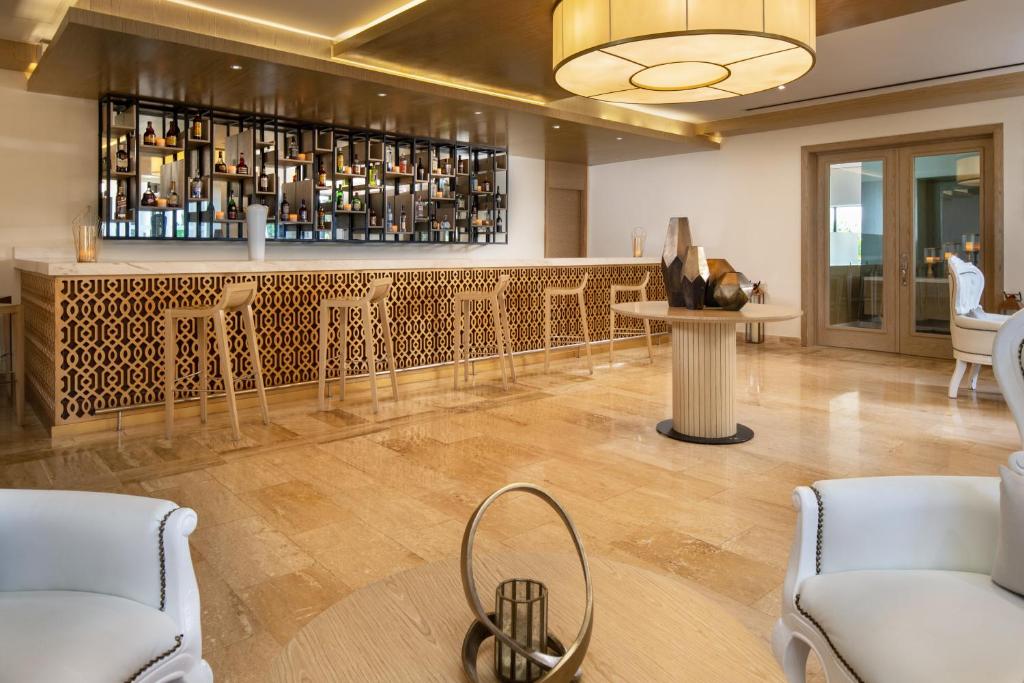 Elegants bārs ar modernu dizainu, kurā ir koka un akmens elementi, kā arī plaša dzērienu izvēle. Interjers ir gaišs un stilīgs, radot patīkamu atmosfēru atpūtai.