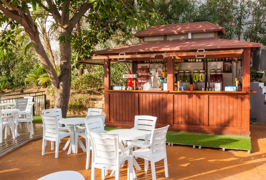 Koka bārs ar dzērieniem un sēdvietām ārpusē, ko ieskauj zaļumi un koki. Ideāla vieta relaksācijai un atspirdzinošiem dzērieniem.