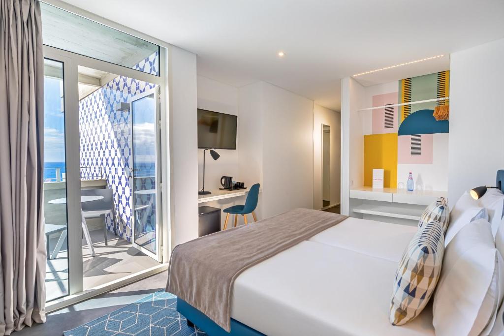 Mūsdienīgs viesnīcas numurs ar balkonu, kas piedāvā skatu uz jūru. Interjers ir gaišs un krāsains, ar modernām mēbelēm un ērtām iekārtām.