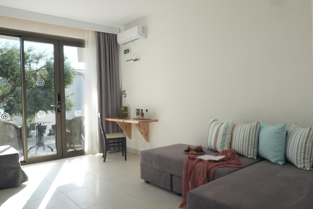 Mūsdienīgs viesnīcas numurs ar ērtu dīvānu, koka galdiņu un skatu uz āru. Interjerā valda gaišas krāsas un dabīgais apgaismojums.