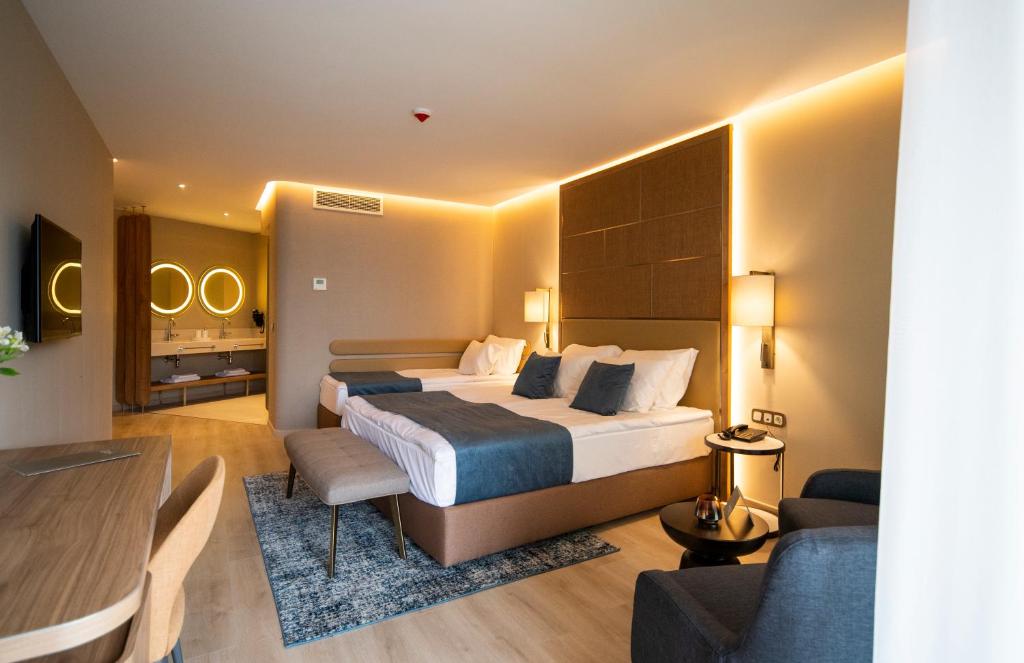 Moderns viesnīcas numurs ar divām gultām, ērtu sēžamo stūrīti un stilīgu apgaismojumu. Numurā ir televizors un pieeja vannas istabai ar mūsdienīgu dizainu.