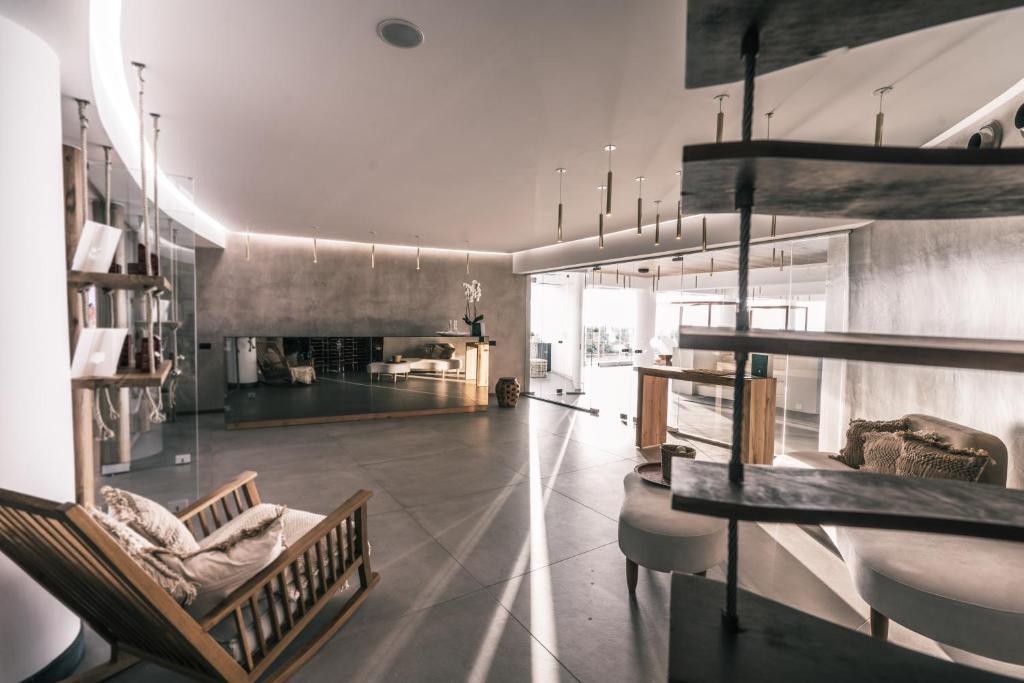 Mūsdienīga un eleganta interjera skats ar plašu telpu, gaišām krāsām un stilīgām mēbelēm. Telpā ir liela atvērta zona ar dabiskiem apgaismojumiem un modernām dekorācijām.