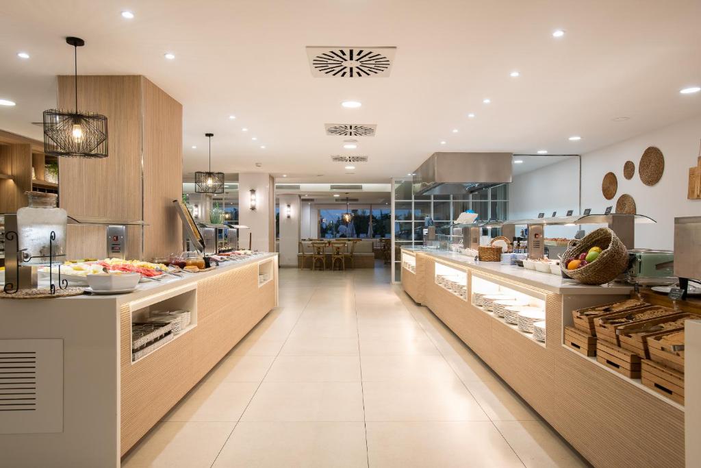 Moderns restorāna interjers ar bufeti, kas piedāvā dažādus ēdienus un dzērienus. Gaisma rada patīkamu atmosfēru, savukārt koka elementi piešķir siltumu un mājīgumu.