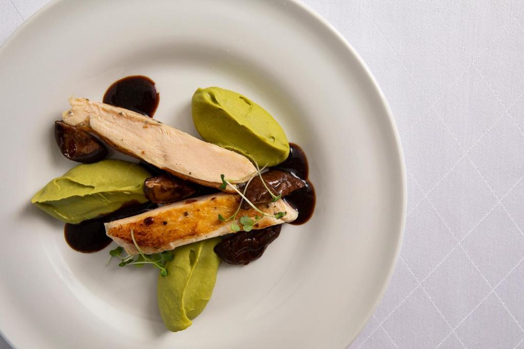 Gourmet dish with chicken and green puree at Sunrise Jade.
