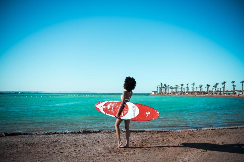 Skeitborda entuziasts pie Meraki Resort, piekrastē ar zilu ūdeni