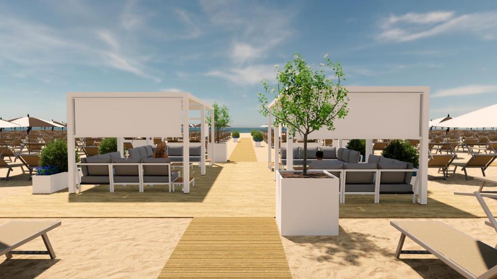 Pludmales zona ar ērtām atpūtas vietām, koka grīdu un ainavu, kas iekļauj palmām un sauļošanās krēsliem. Ideāla vieta relaksācijai pie jūras.