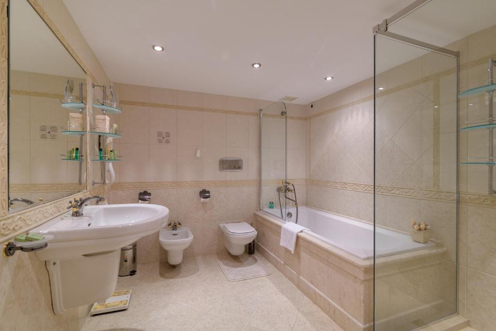 Mūsdienīga un eleganta vannas istaba ar vannu, dušu un modernu izskatu. Interjers ir veidots ar smalkām flīzēm un stilīgu apgaismojumu.