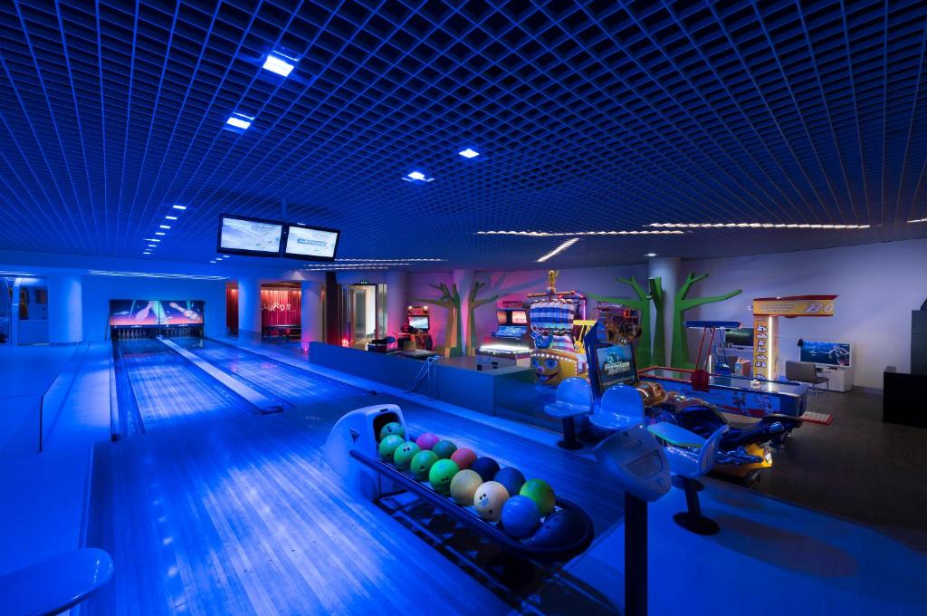 Bowling zone at Akra Kemer with vibrant neon lights and arcade games.