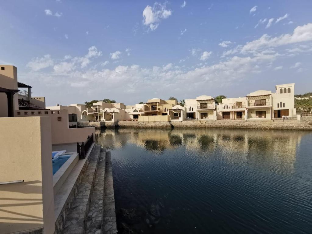 The Cove Rotana Resort villas overlooking tranquil water.