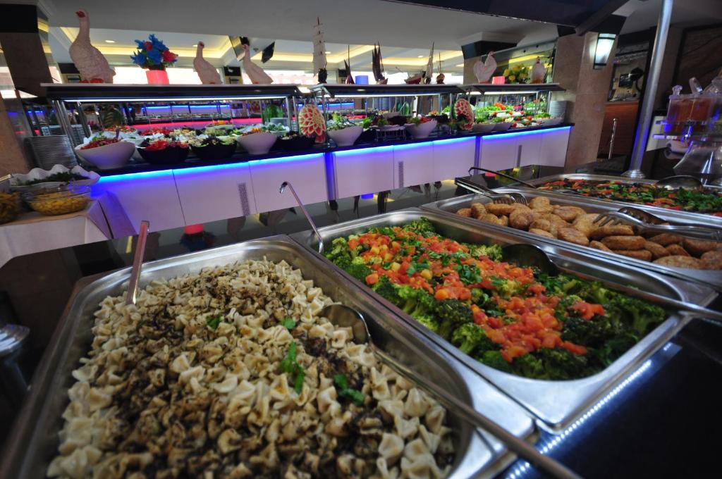 Buffet spread featuring pasta, fresh salads, and colorful vegetables at Camyuva Beach Hotel