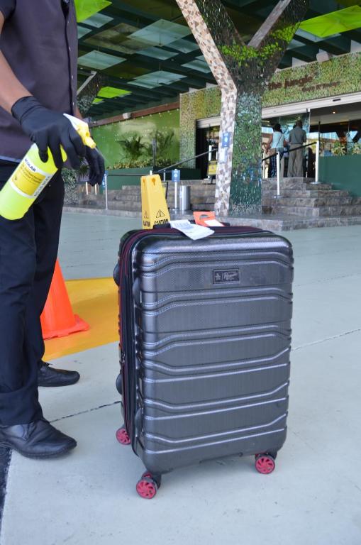 Drošības procedūra pie Hard Rock Hotel Cancun ar ceļojumu bagāžu.