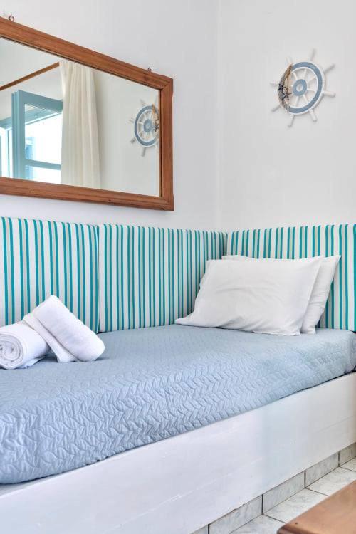 Mūsdienīgs guļamstūris ar zilu un baltu svītru apdari, spilvenu un dvieļiem, kā arī lielu spoguli. Sienā ir jūras stūres elements, kas piešķir telpai jūras noskaņu.