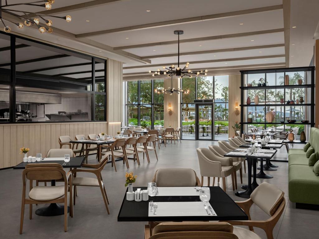Mūsdienīgs restorāns ar elegantu interjeru, kurā ir koka mēbeles un plašas logu vitrīnas. Gaismas elementi un zaļi augi papildina patīkamo atmosfēru.