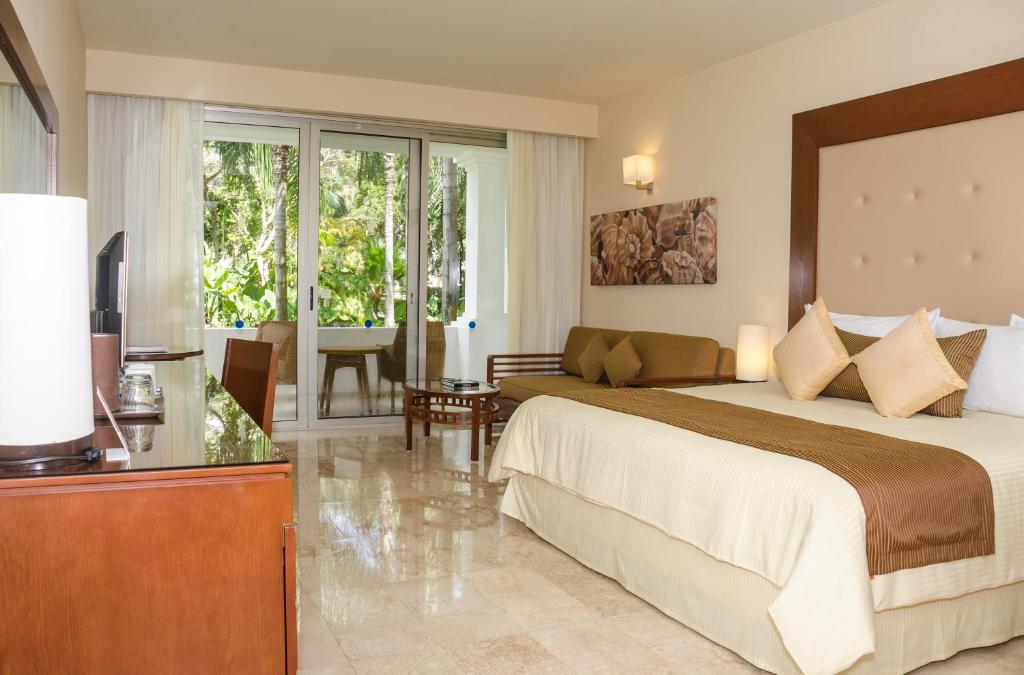 Luksusa viesnīcas numurs ar plašu logu, kas paver skatu uz dārzu, modernu mēbeli un elegantu interjeru. Ideāla vieta atpūtai un relaksācijai.