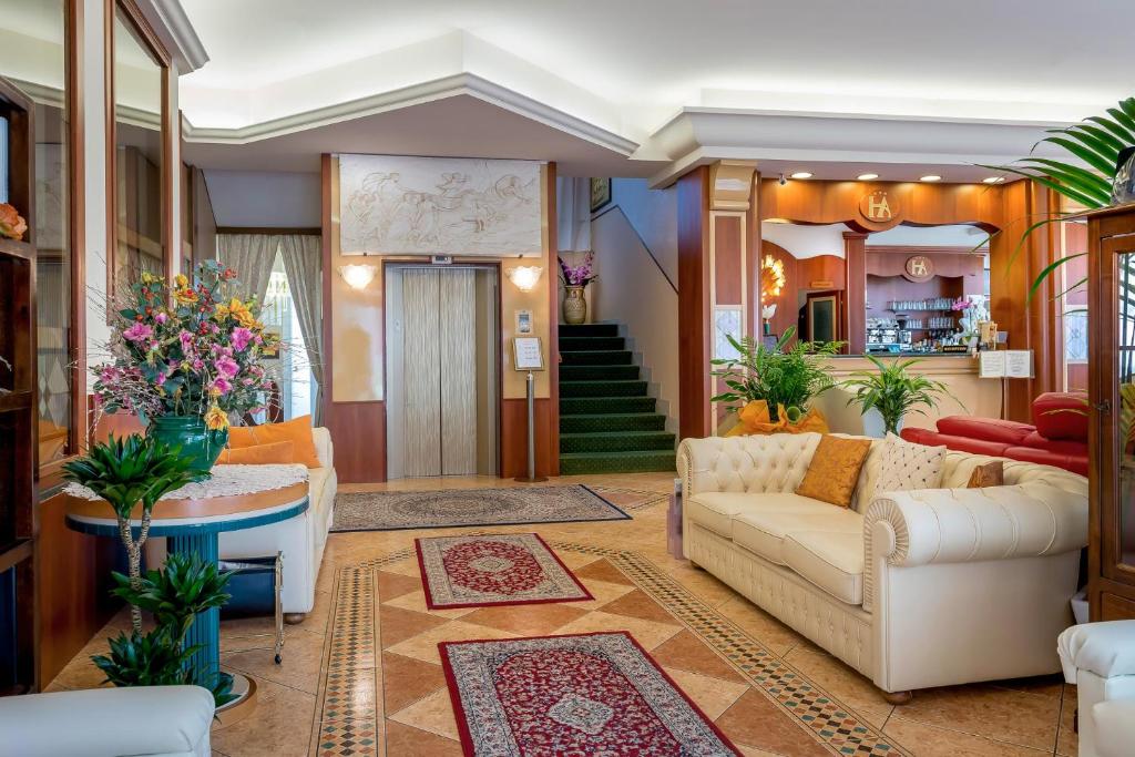 Elegants viesnīcas vestibilis ar ērtiem dīvāniem, krāšņām puķēm un modernu apgaismojumu. Iekārtots ar kāpnēm uz otro stāvu un bāru, kas viesiem piedāvā atsvaidzinošus dzērienus.