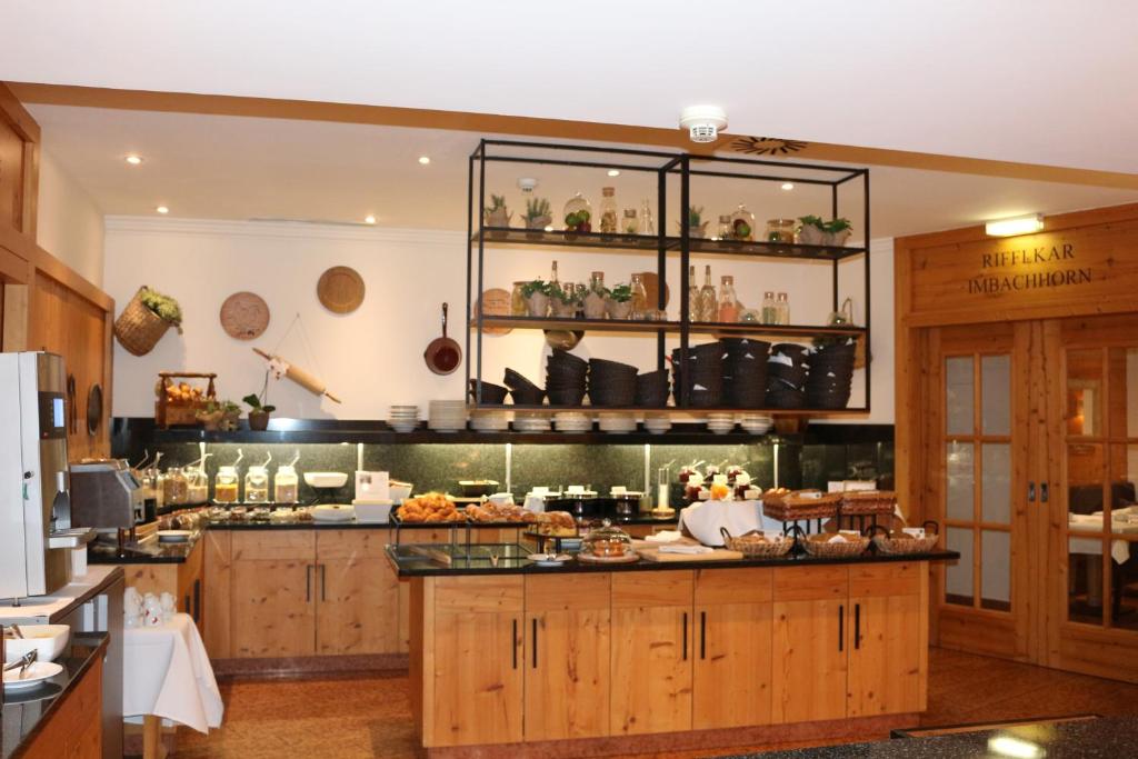 Kafijas bufete ar koka mēbelēm un dažādiem gardumiem, ieskaitot augļus un konditorejas izstrādājumus, atrodas mājīgā telpā. Dārza elementi un dekorācijas veido siltu atmosfēru.