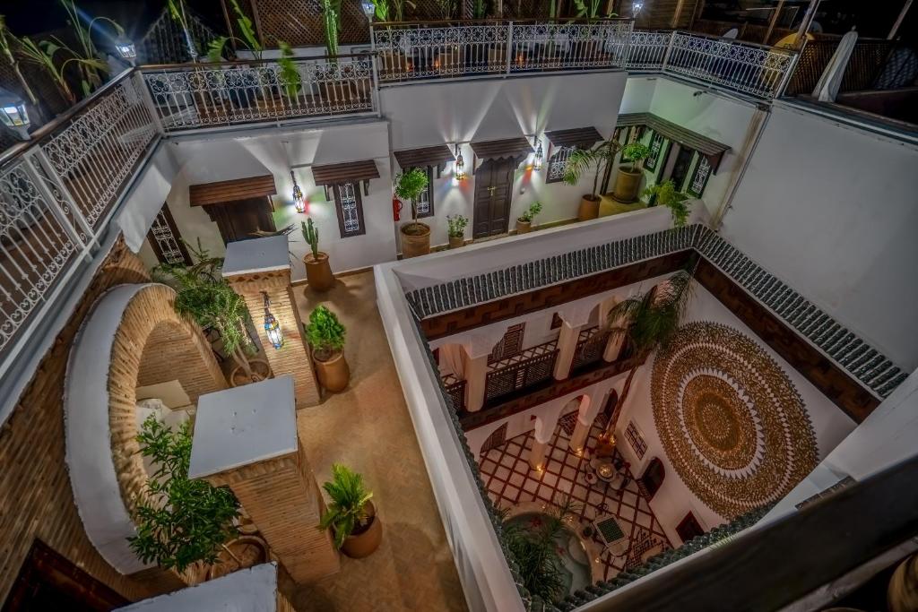 Mūsdienīgs viesnīcas iekšpagalms ar elegantiem augiem un arhitektūras detaļām, kas radījušas patīkamu atmosfēru. Gaismas elementi un tradicionālais dizains veido burvīgu noskaņu.