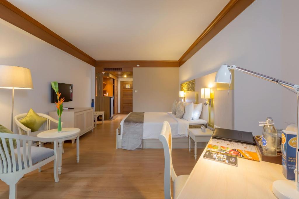 Mūsdienīgs viesnīcas numurs ar ērtu gultu, rakstāmgaldu un viesistabas zonu, kurā ir gaismas un dekoratīvie elementi. Numurā ir televizors un mini ledusskapis, radot mājīgu atmosfēru.