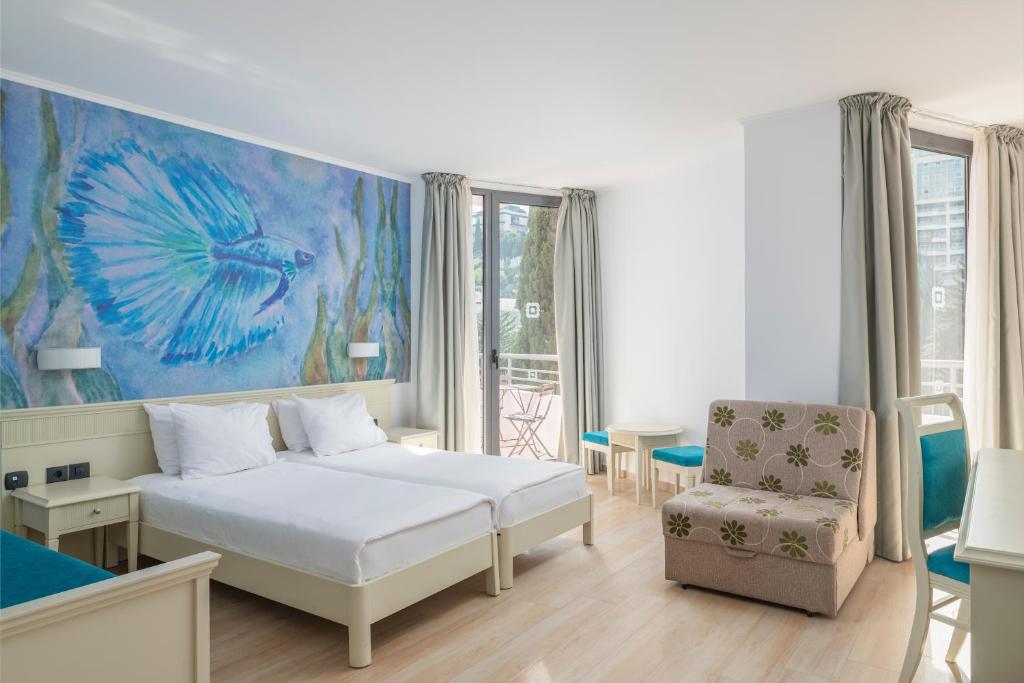 Mūsdienīgs viesnīcas numurs ar divām vienguļamām gultām, gaišām krāsām un krāsainu sienas gleznojumu, kas attēlo zivtiņu. Numurā ir dabiskais apgaismojums un ērtas mēbeles.