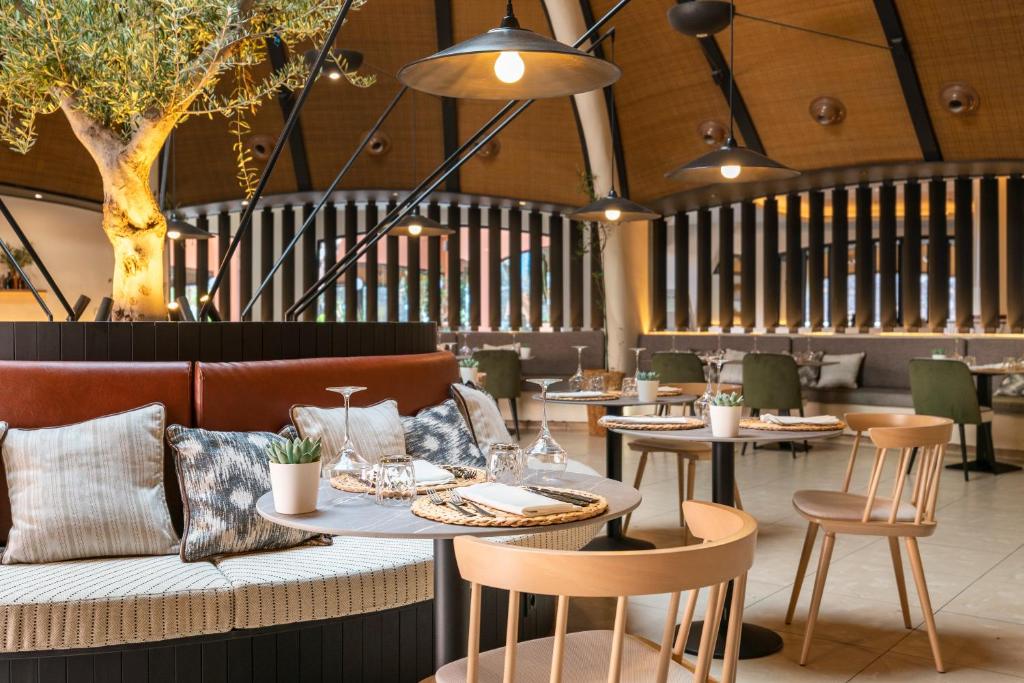 Mūsdienīgs un elegants restorāna interjers ar dabīgu koku un stilīgām mēbelēm, kas rada komfortablu atmosfēru. Piezīmju galdi un dekoratīvi elementi papildina kopējo dizainu.