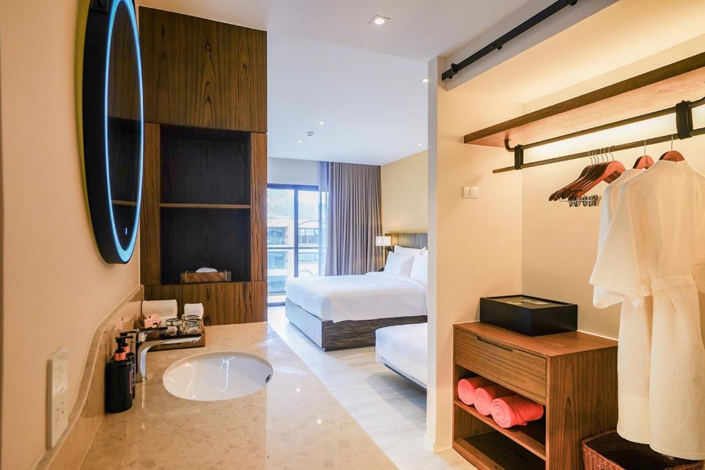 Mūsdienīga viesnīcas numura iekārtojums ar gaismu atstarojumu un ērtu vannas istabu. Numurā iekļauti drēbju pakaramie un atpūtas zona ar skatu uz āra terasi.