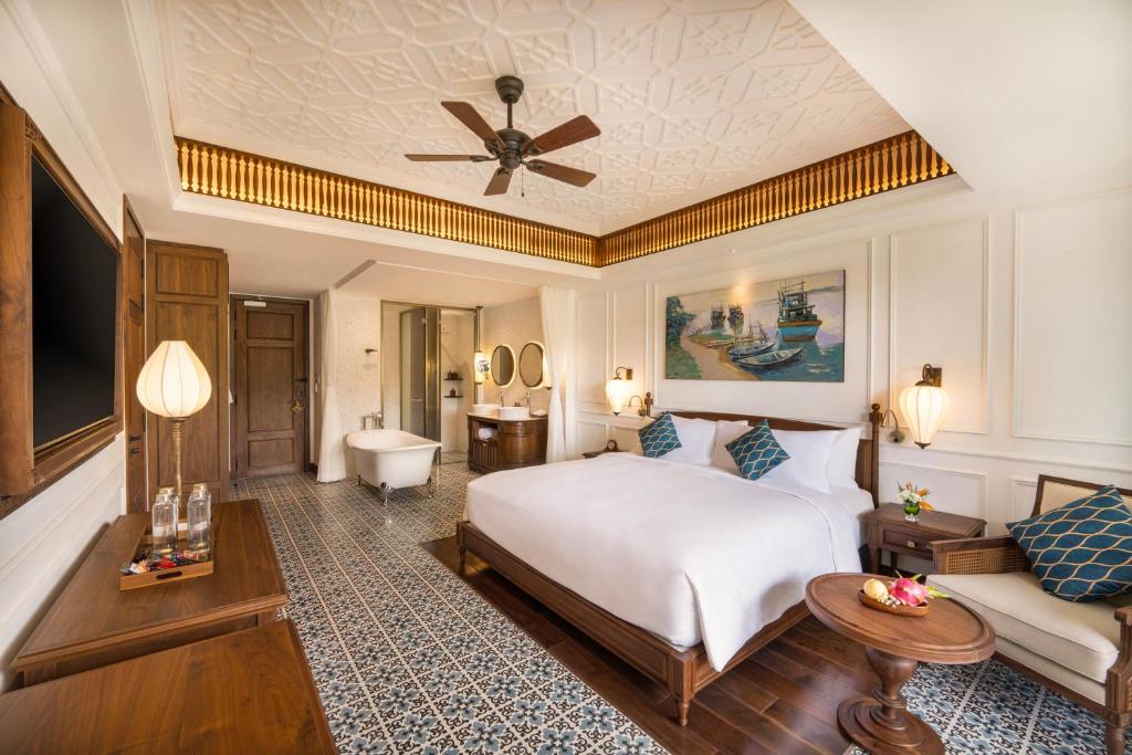 Mūsdienīgs viesnīcas numurs ar elegantu dekoru, komfortablu gultu un stilīgu mēbeļu komplektu. Interjerā ir redzama gleznaina ainava un grezns grīdas segums.