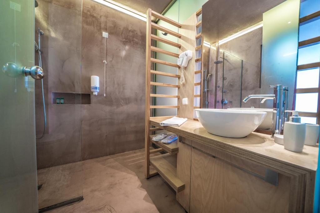 Panorama Village Hotel numura vannas istaba ar mūsdienīgu betona un koka apdari.