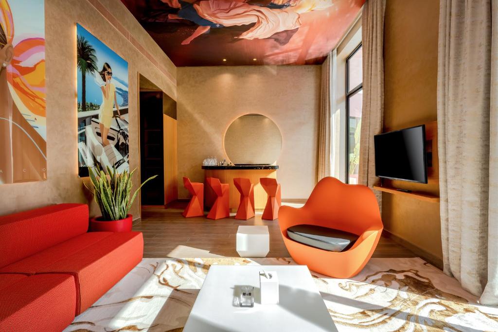 Modern suite at Voco Monaco Dubai with vibrant decor.
