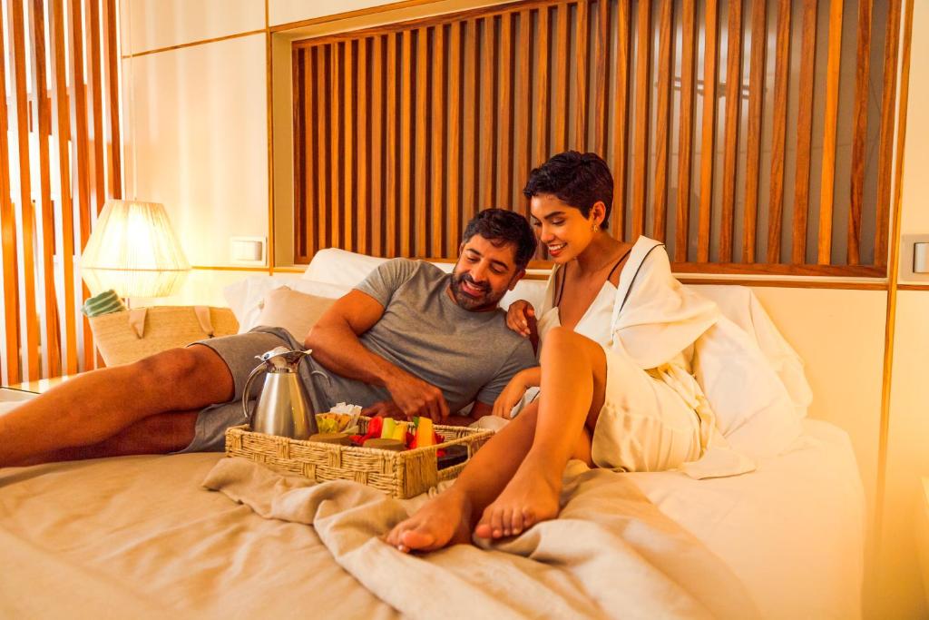 Jauns pāris baudot brokastis gultā viesnīcā Paradisus Playa del Carmen.