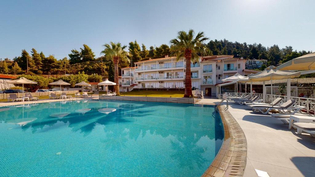 Viesnīca ar baseinu un palmu ainavu, kas piedāvā relaksējošu atmosfēru. Ideāla vieta atpūtai un brīvdienām.