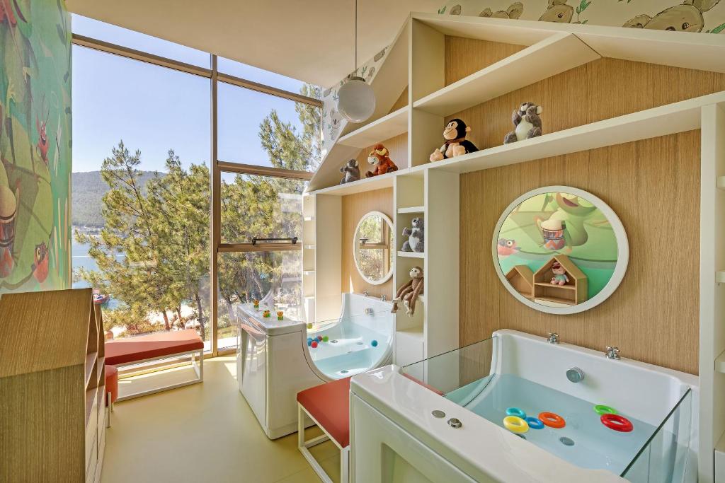 Bērnu izklaides telpa Titanic Luxury Collection Bodrum ar rotaļlietām un vannām.