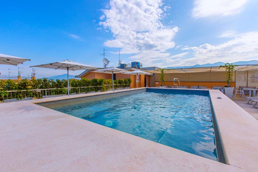 Terases baseins ar saulessargiem un skatu uz debesīm, ideāla vieta relaksācijai un atpūtai.