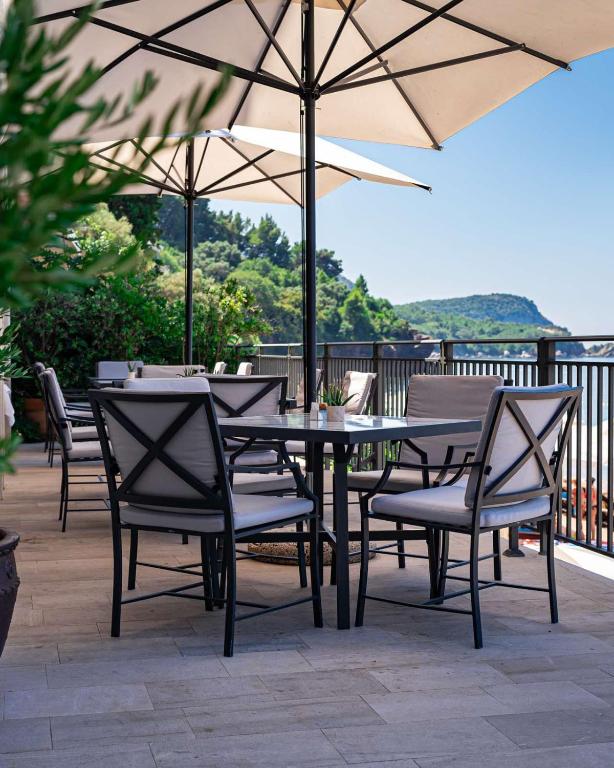 Āra terase ar ērtām krēslām un lieliem saules aizsargiem, kas piedāvā skatu uz kalniem un jūru. Ideāla vieta relaksācijai un atpūtai brīvā dabā.