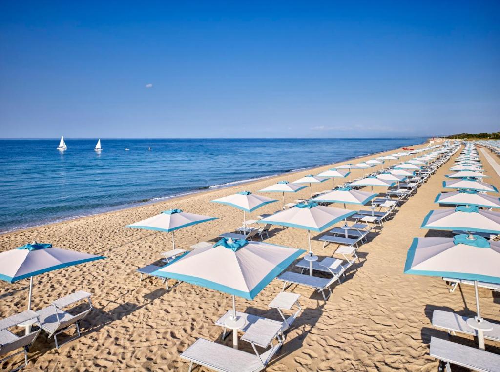 Serene Resort pludmale ar saulessargiem un sauļošanās krēsliem