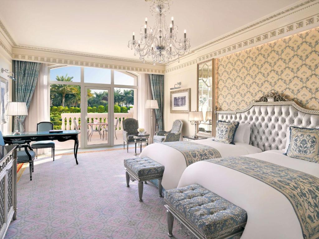 Elegants viesnīcas numurs ar divām gultām, greznu dekori un skatu uz dārzu. Telpā ir plašs logs, stilīgs rakstāmgalds un grezni gaismas ķermeņi.