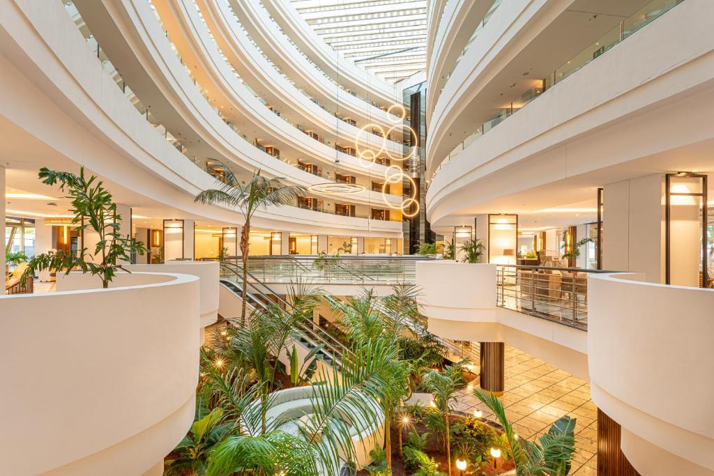 Mūsdienīgs interjers ar plūstošām līnijām un zaļumiem, kas rada relaksējošu atmosfēru. Gaismas interjera elementi piešķir telpai eleganci un siltumu.