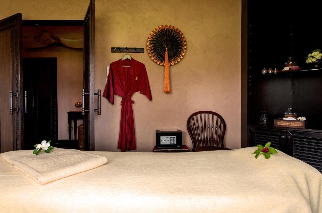 Katathani Phuket Beach Resort spa numurs ar masāžas galdu un sarkanu halātu