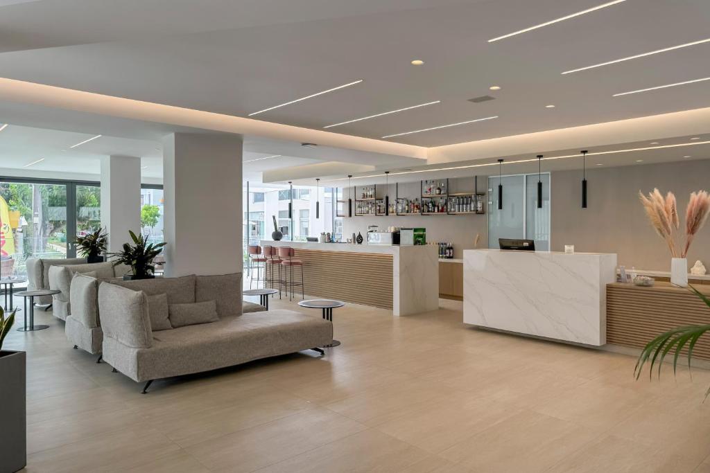 Mūsdienīgs viesnīcas reģistratūras un atpūtas zona ar elegantu dizainu, gaišiem toņiem un minimālistiskām mēbelēm. Telpā ir bārs un sēdvietas atpūtas brīžiem.