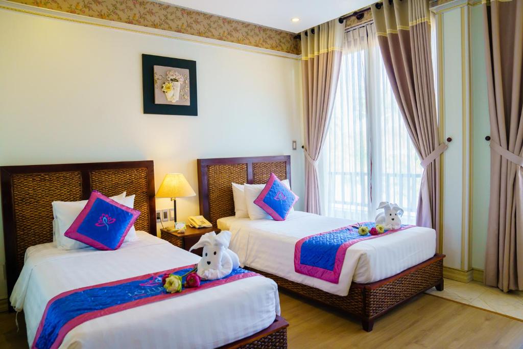 Mūsdienīgs viesnīcas numurs ar divām gultām, dekorēts ar spilveniem un ziediem, piedāvā komfortablu atpūtu. Labi apgaismots ar lieliem logiem, kas sniedz skatu uz ārpusi.