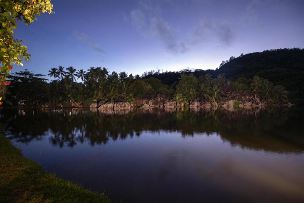 Kempinski Seychelles Resort mierīgā lagūna un tropu daba krēslas stundā