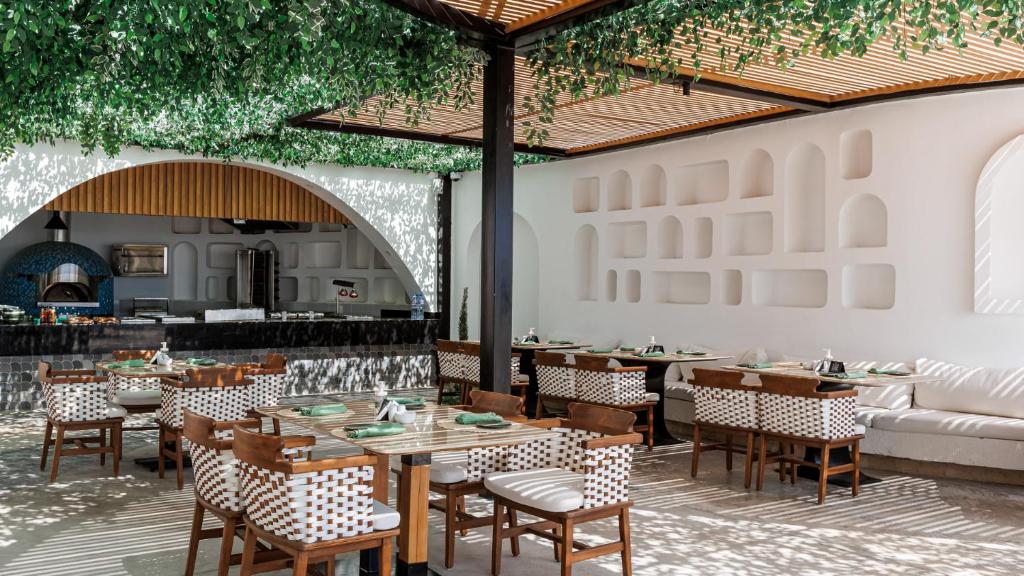 Restorāns Sunrise Remal Beach Resort ar zaļiem augiem un modernu dizainu.