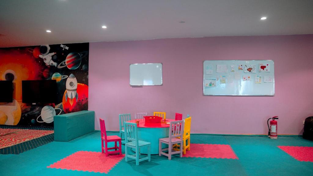 Bērnu rotaļu istaba Ali Baba Palace Resort ar krāsainām mēbelēm un kosmosa motīviem.