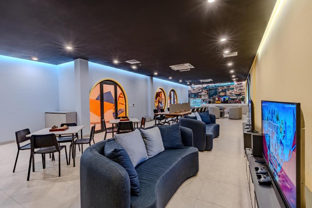 Mūsdienīgs atpūtas stūris Bergiz Hotels & Resort Kemer ar dīvāniem un spēļu zonu.