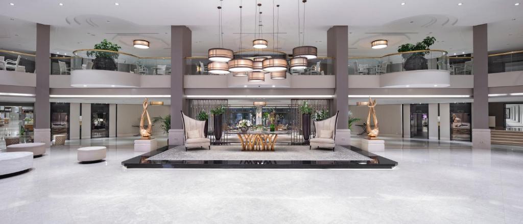 Moderns viesnīcas Mirage Park Resort vestibils ar elegantiem gaismas elementiem.