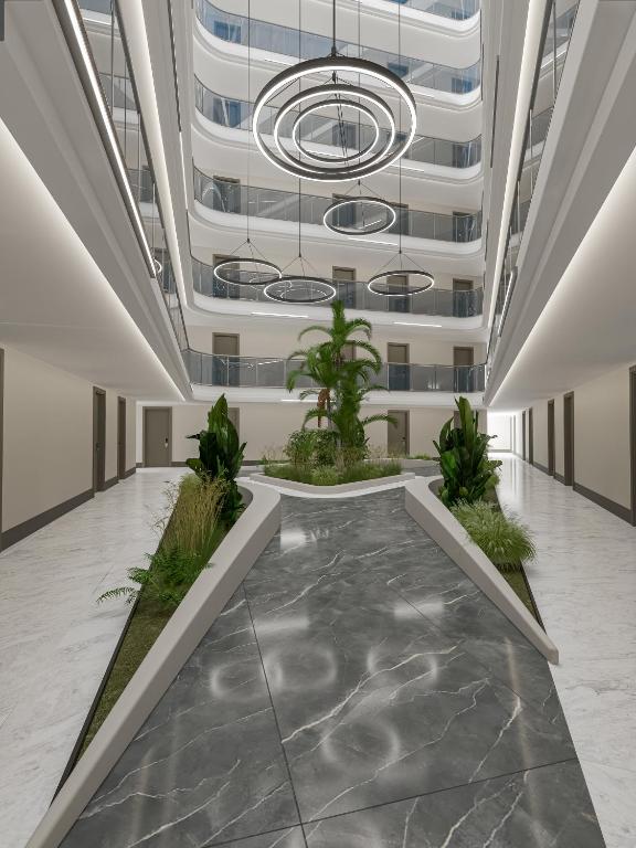 Mūsdienīgs iekšējais pagalms Annabella Diamond Hotel ar augiem un modernām gaismām.