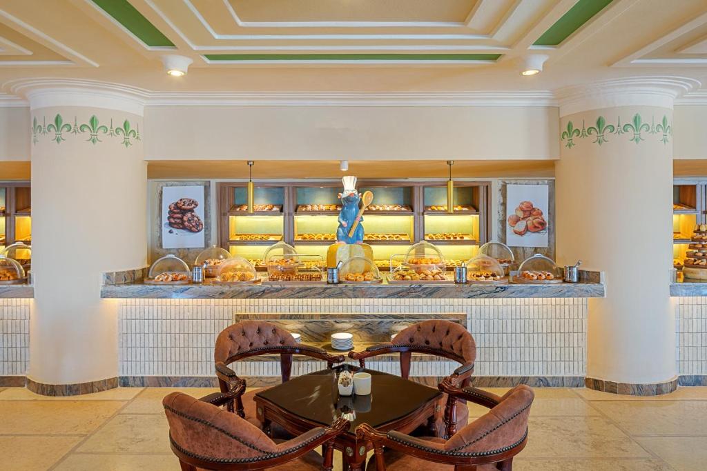 Bakery display at Pickalbatros Citadel Resort with pastries and seating area.