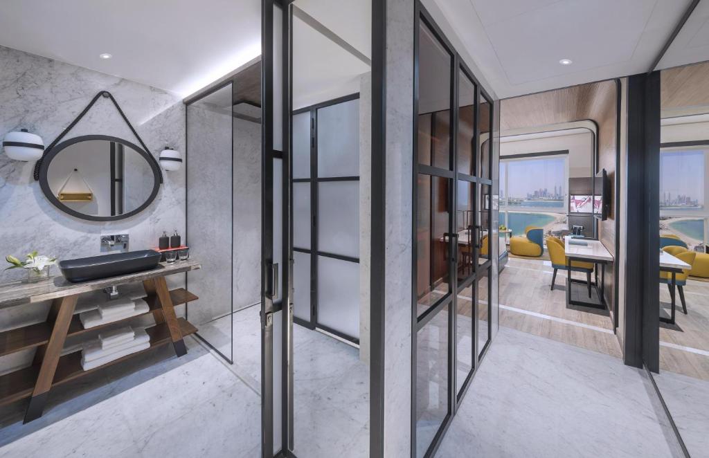 Andaz Dubai The Palm numurs ar skatu uz jūru un modernu vannasistabu.