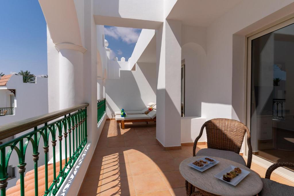 Balkons ar ērtām mēbelēm pie Baron Palms Resort, saulains skats.
